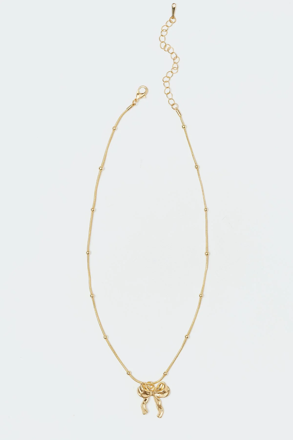 Bow Detail Pendant Necklace in Gold Tone Metal
